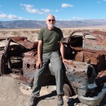Dean with rusted car on Panamint Butte Road, Death Valley