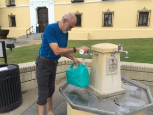 Filling our jug with hot spring water from public tap